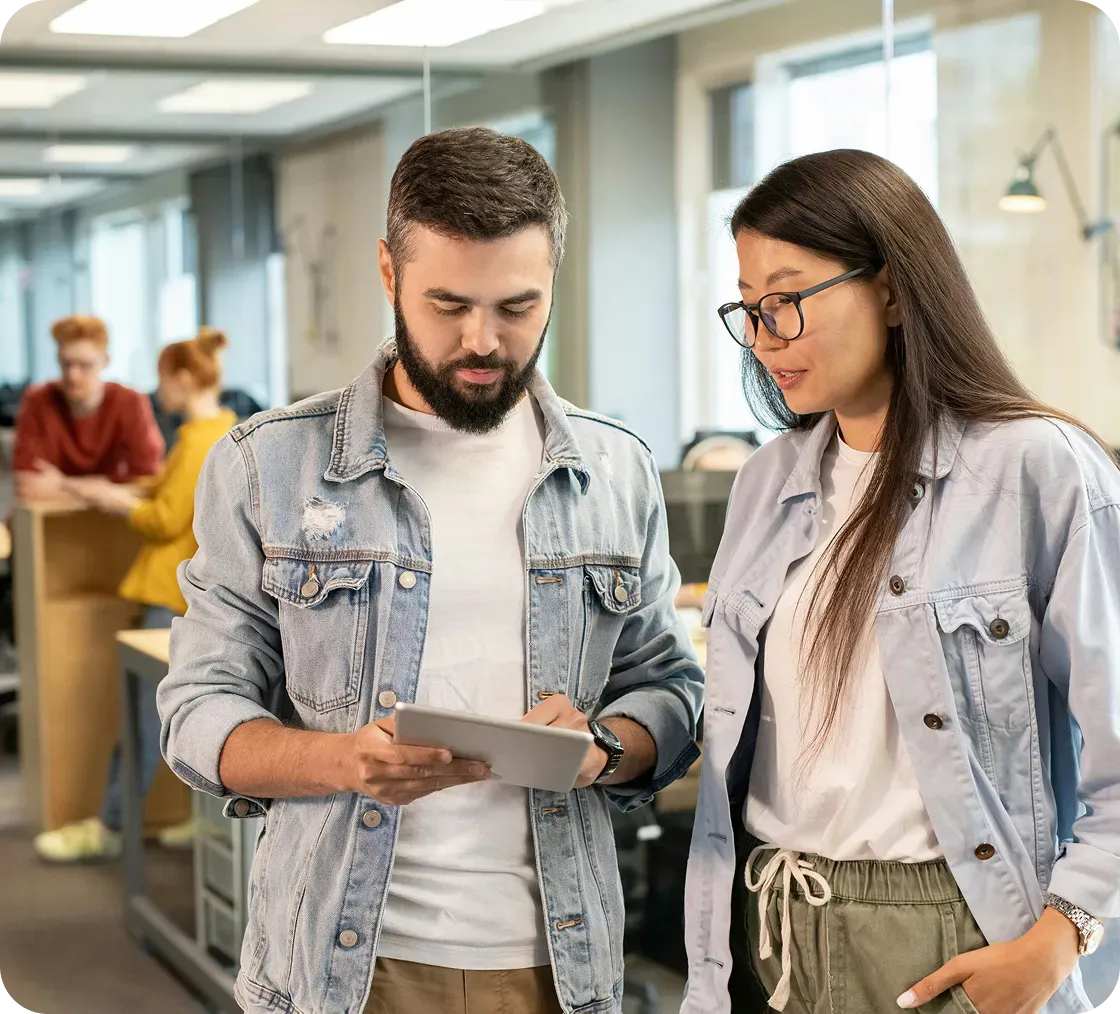 Workers in office looking tablet